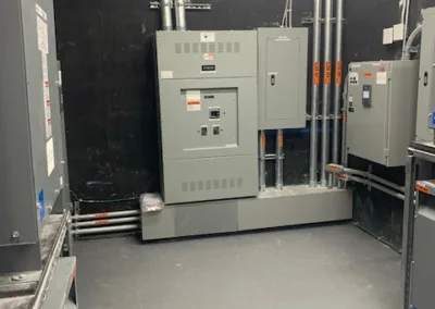 Electrical switchgear and distribution panels installed in an industrial room.